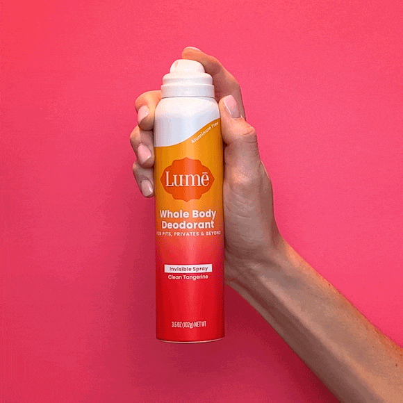 Hand pressing on the top of a can of Lume spray deodorant