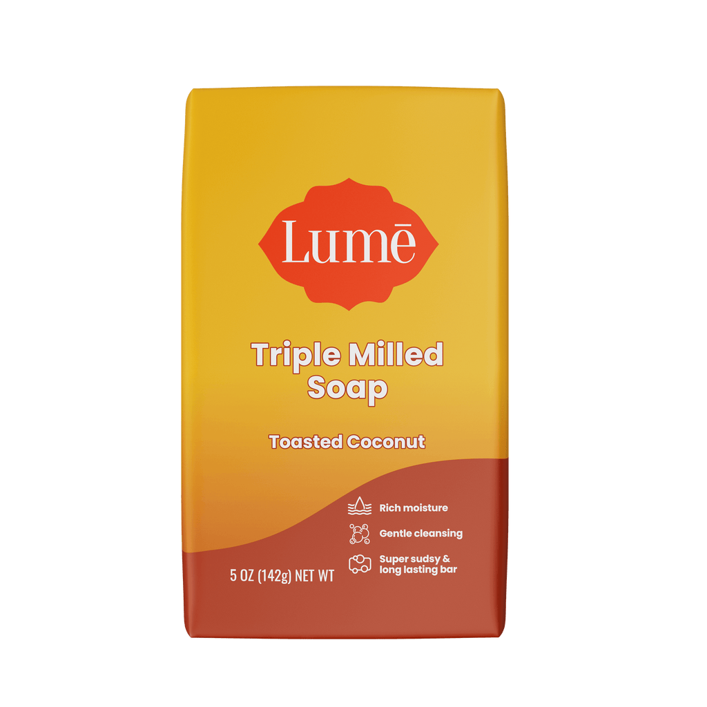 Bright orange Lume toasted coconut scented soap bar against a white background