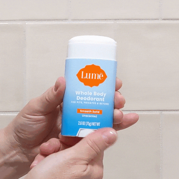 A gif of hands twisting up a stick of deodorant.